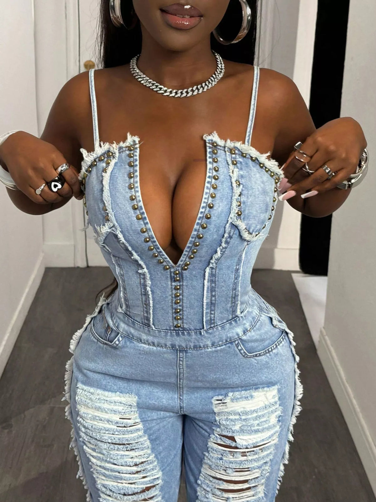 Wide leg denim jumpsuit shown from the side on a model