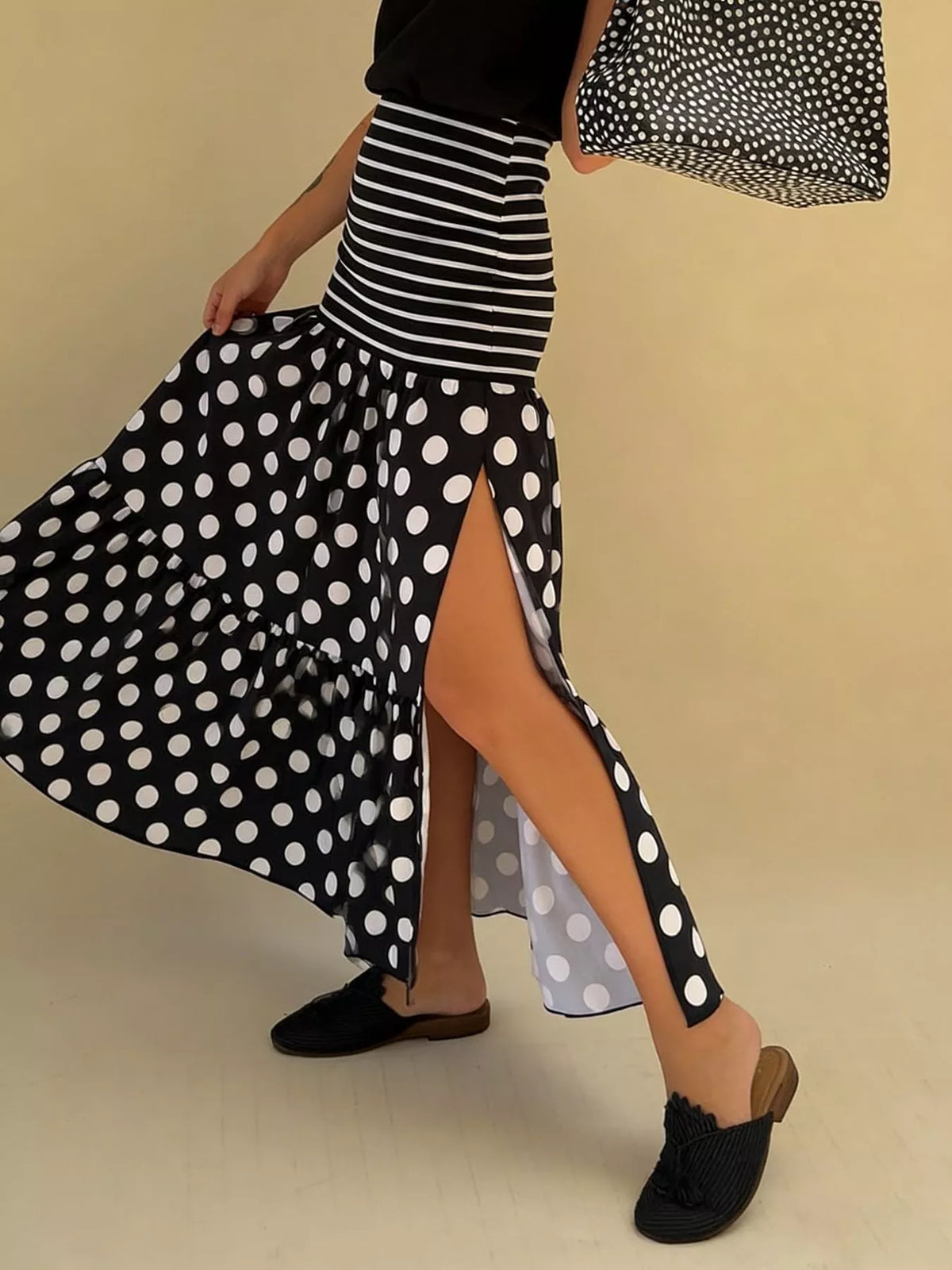 Polka dot striped slit maxi skirt in black full length view