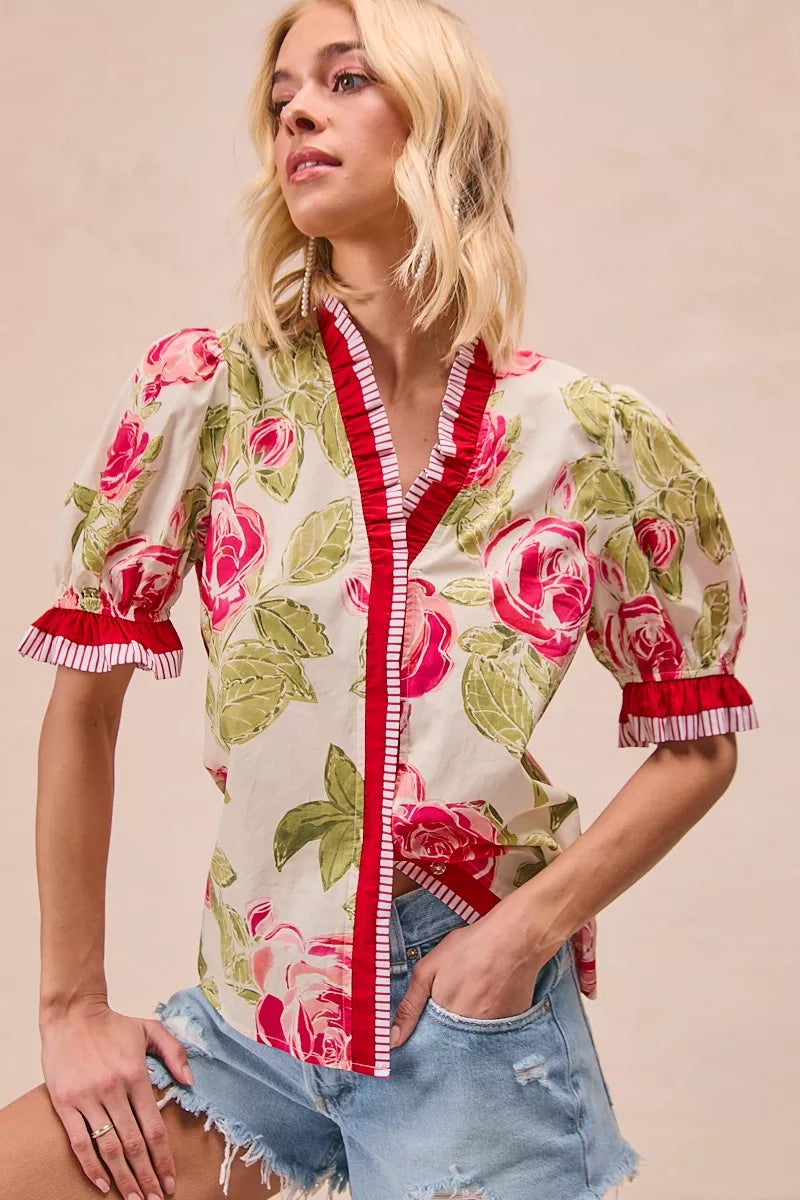 Ruffle detail close up on coral blouse