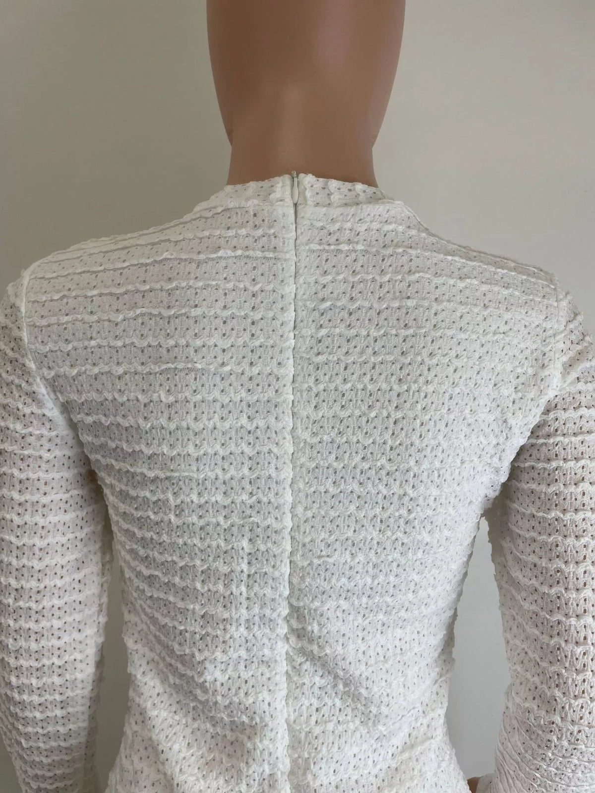 Textured weave fabric close up on the white dress