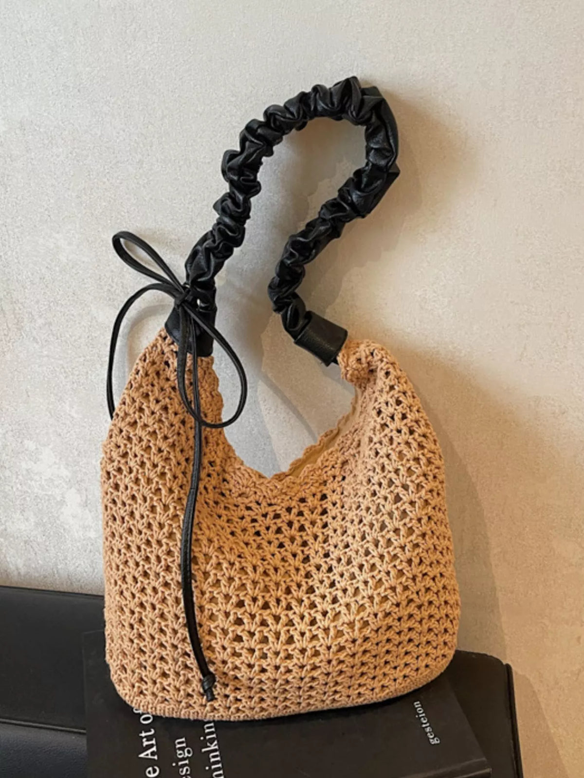 Close up of crochet weave texture on khaki straw bag