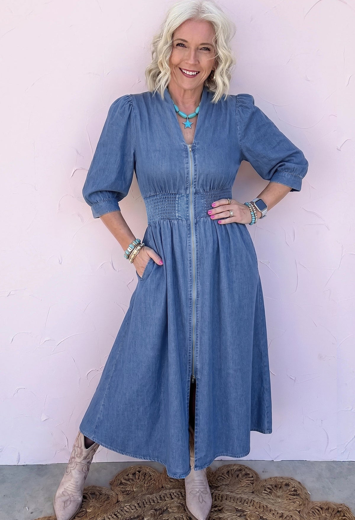 Close up of front metal zipper on blue denim dress