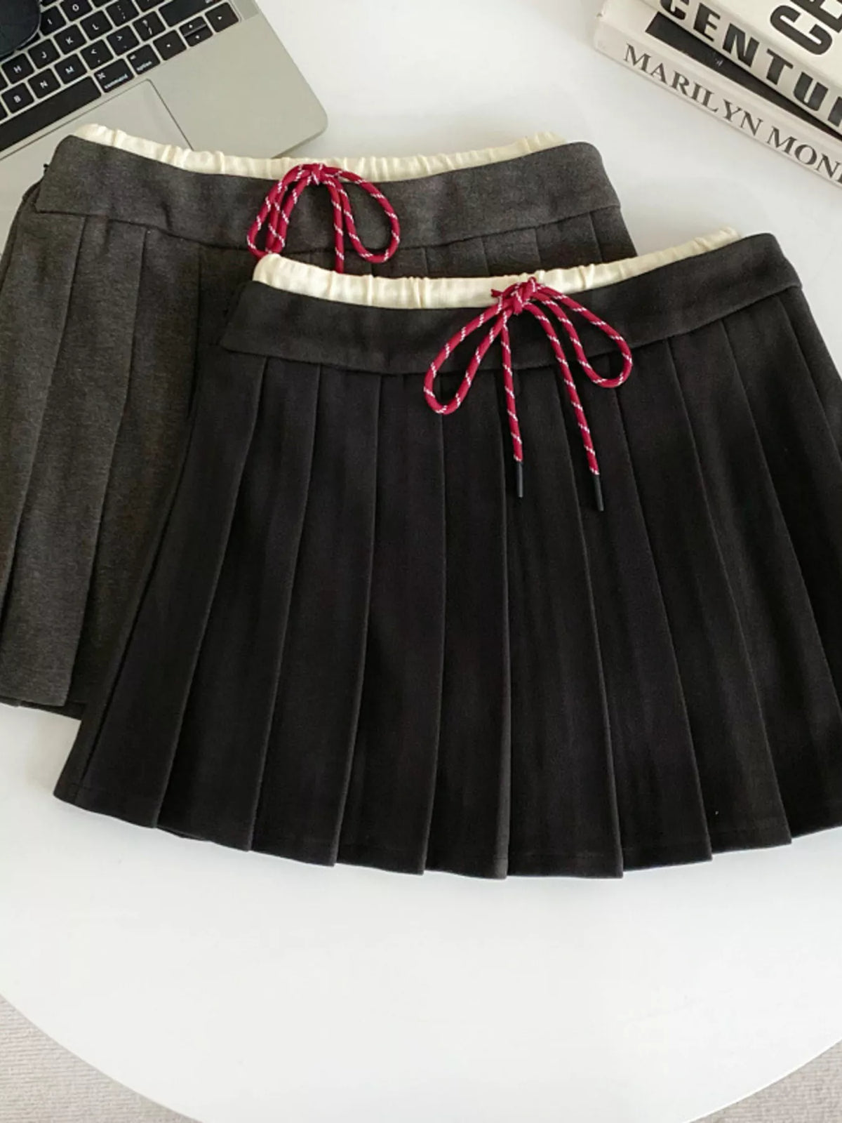 Black pleated mini skirt front view