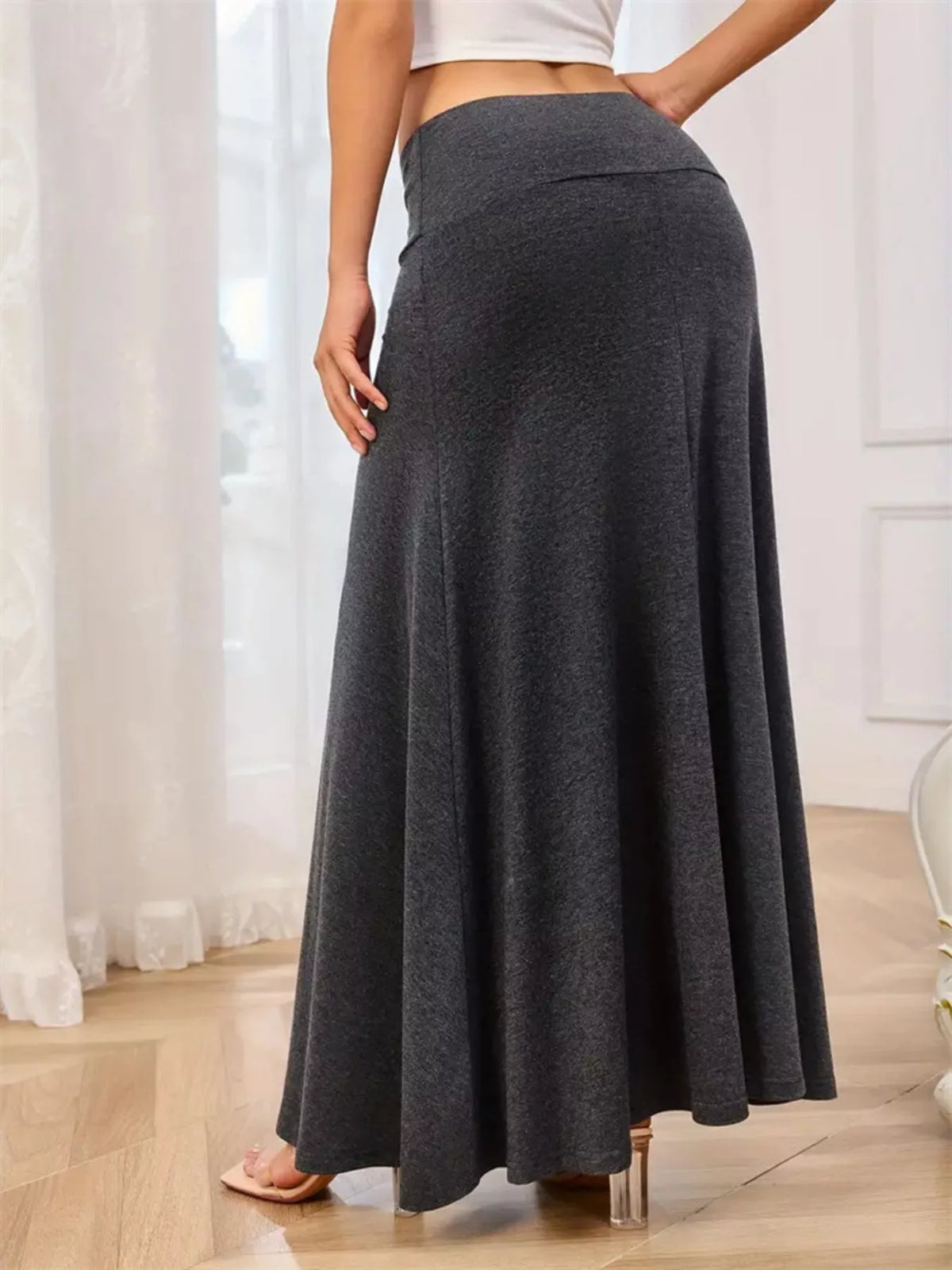 Maxi skirt with wide waistband styled with a tucked top