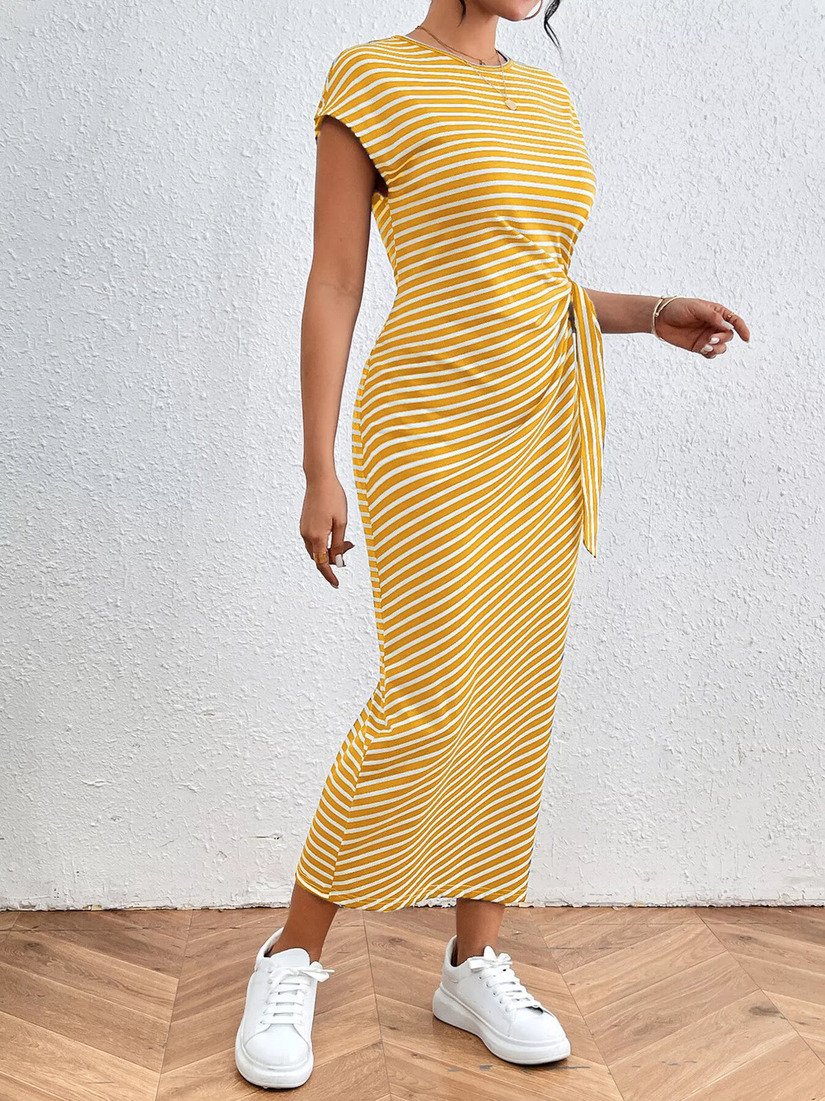 Royal blue striped dress styled on model, side angle