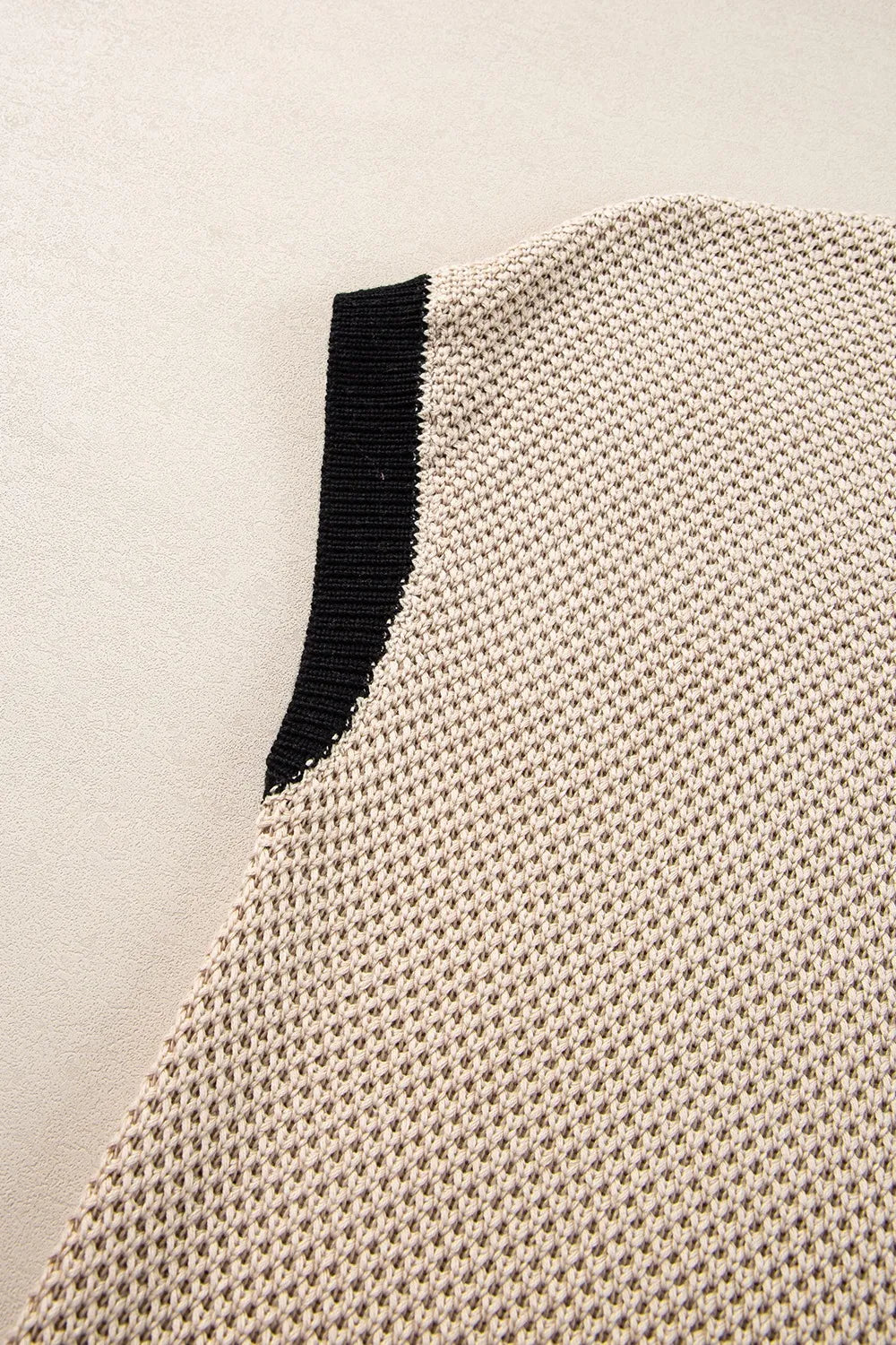 Sleeve detail of contrast trim sweater