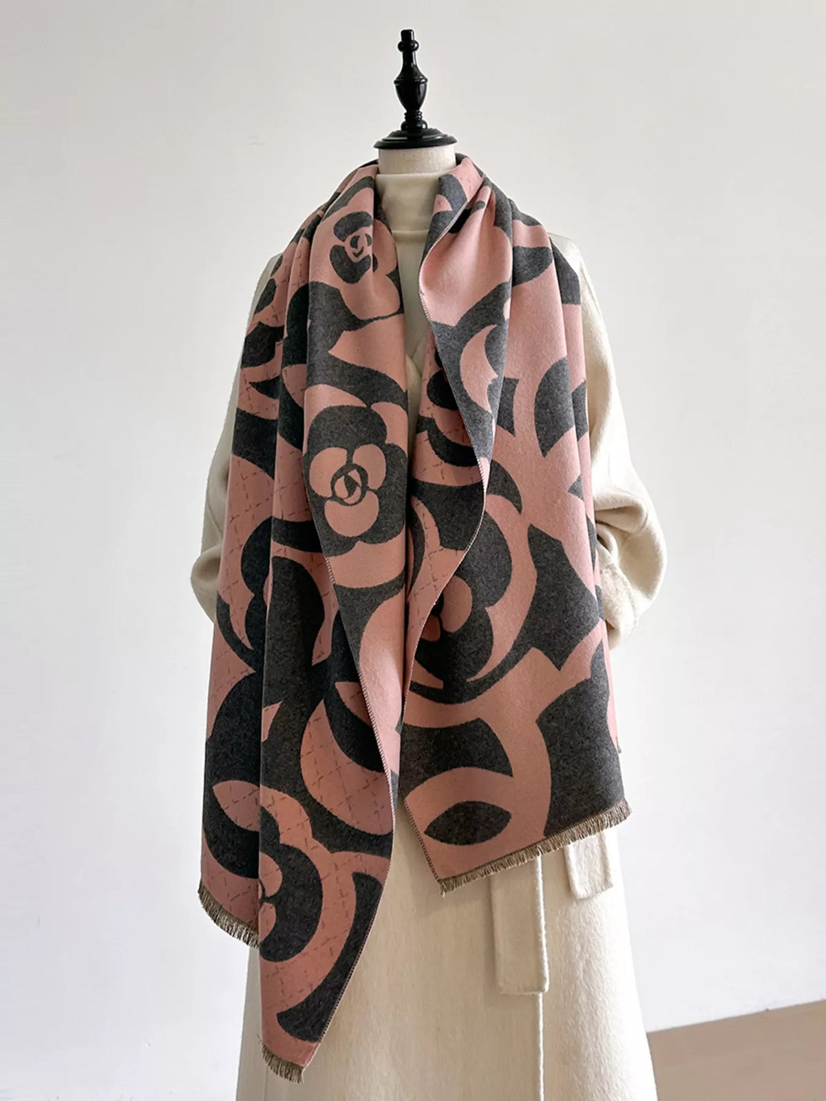 Floral winter scarf styled over a wool coat
