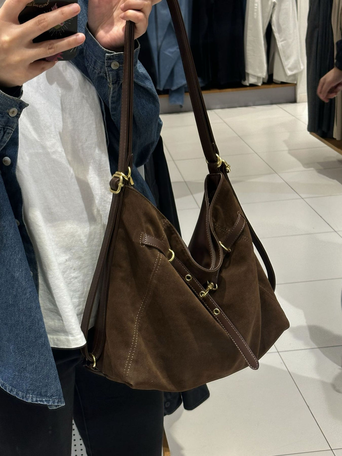Adjustable strap detail on brown nylon bag
