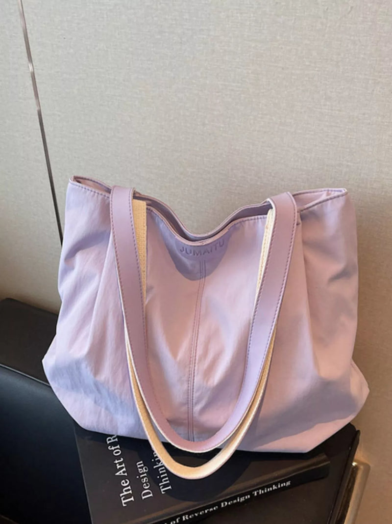 Lightweight canvas shoulder bag in purple front view