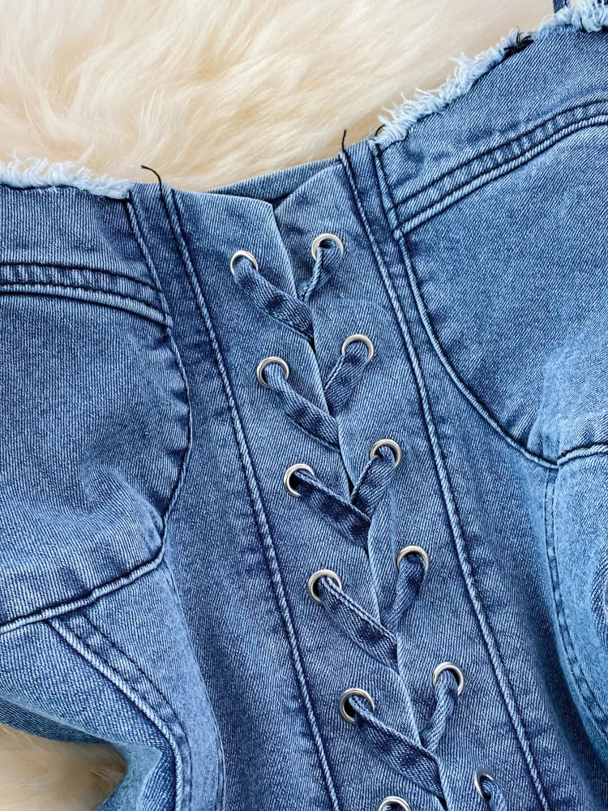 Blue lace up denim A line mini dress on model