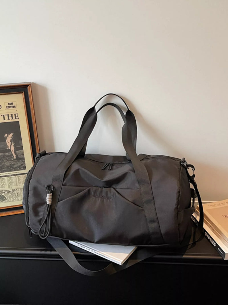 Black lightweight nylon travel duffel bag front view