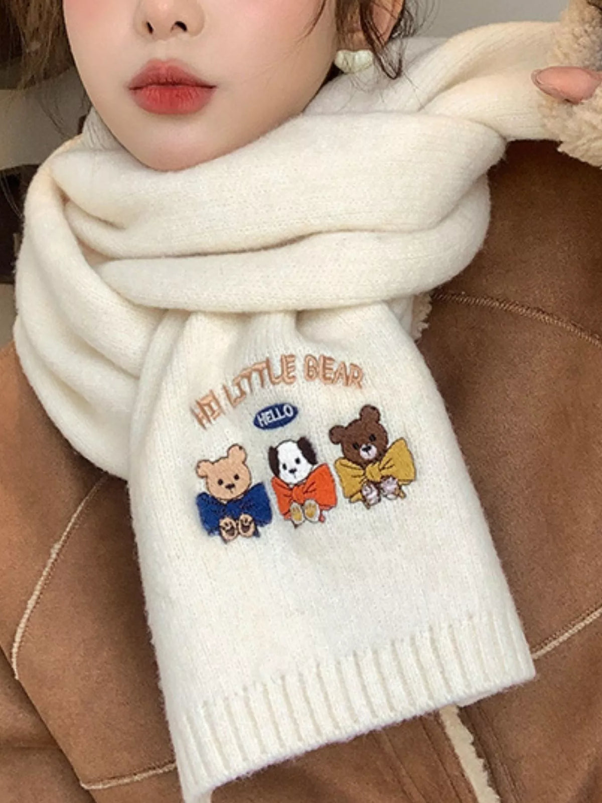 Close view of the embroidered cartoon detail on the scarf