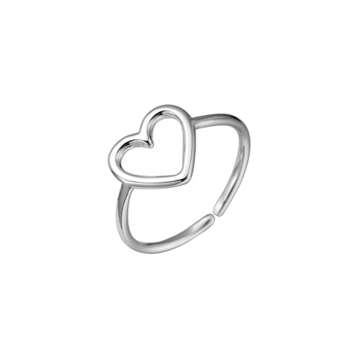 Silver heart open ring styled on the finger