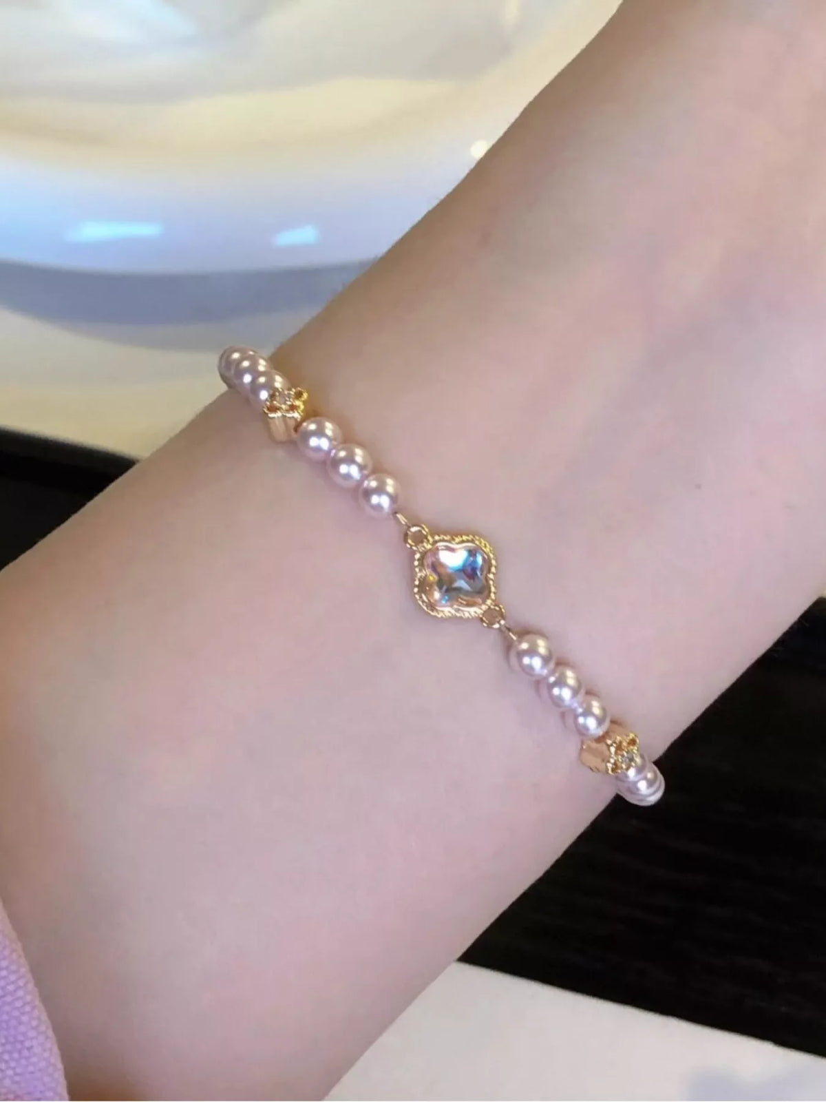 Gold pearl clover charm bracelet detail view