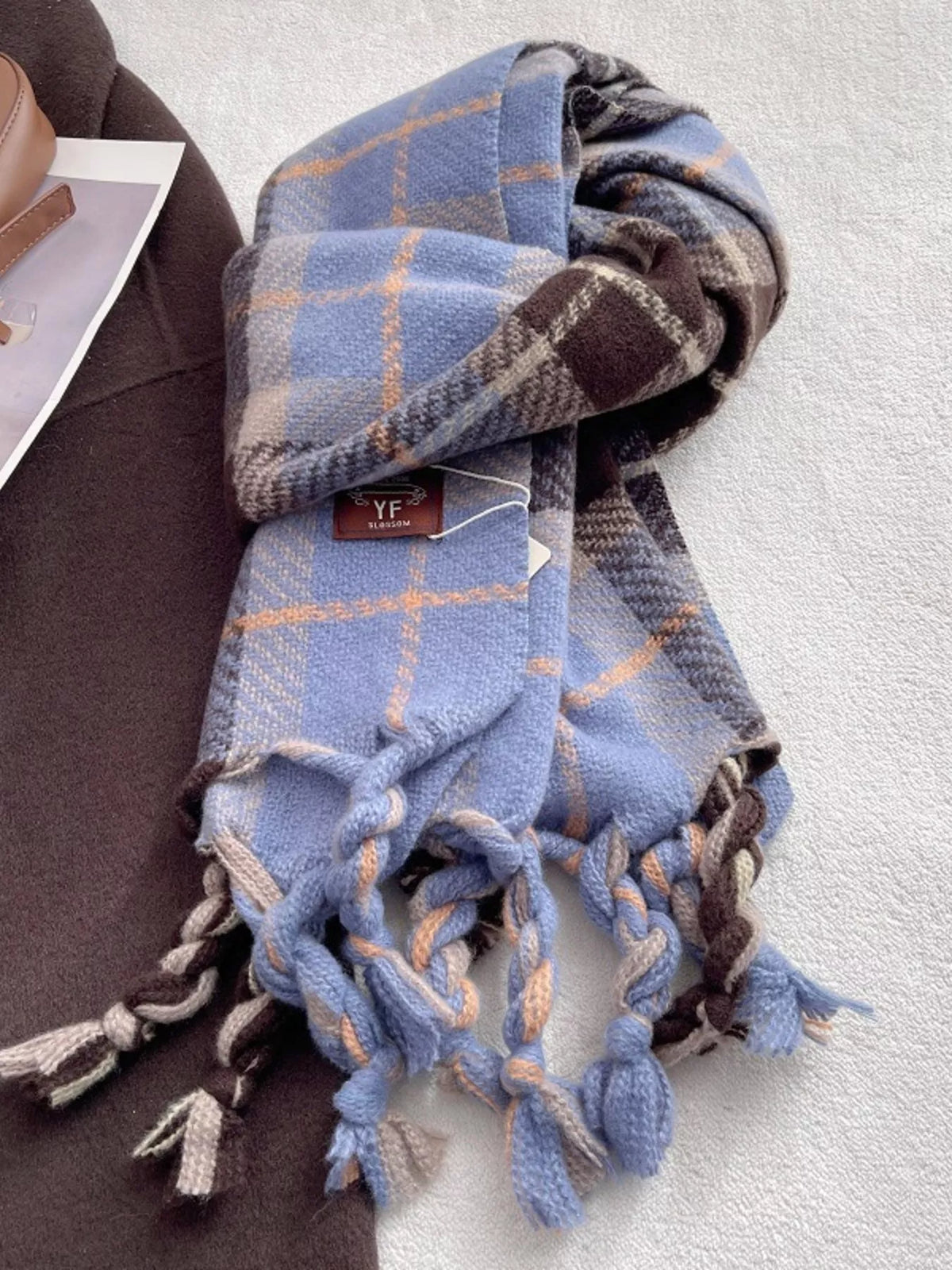 Warm plaid tassel scarf laid flat to show the length