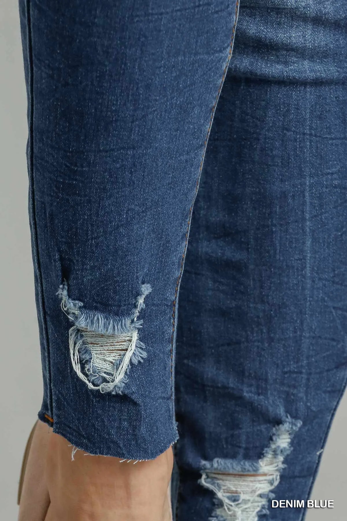 Model wearing distressed high waisted skinny jeans