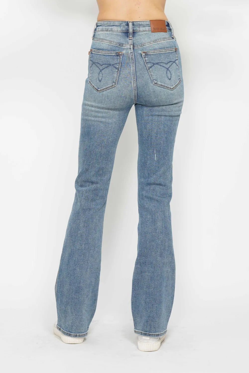 Back view showing the embroidered pocket detail on the jeans