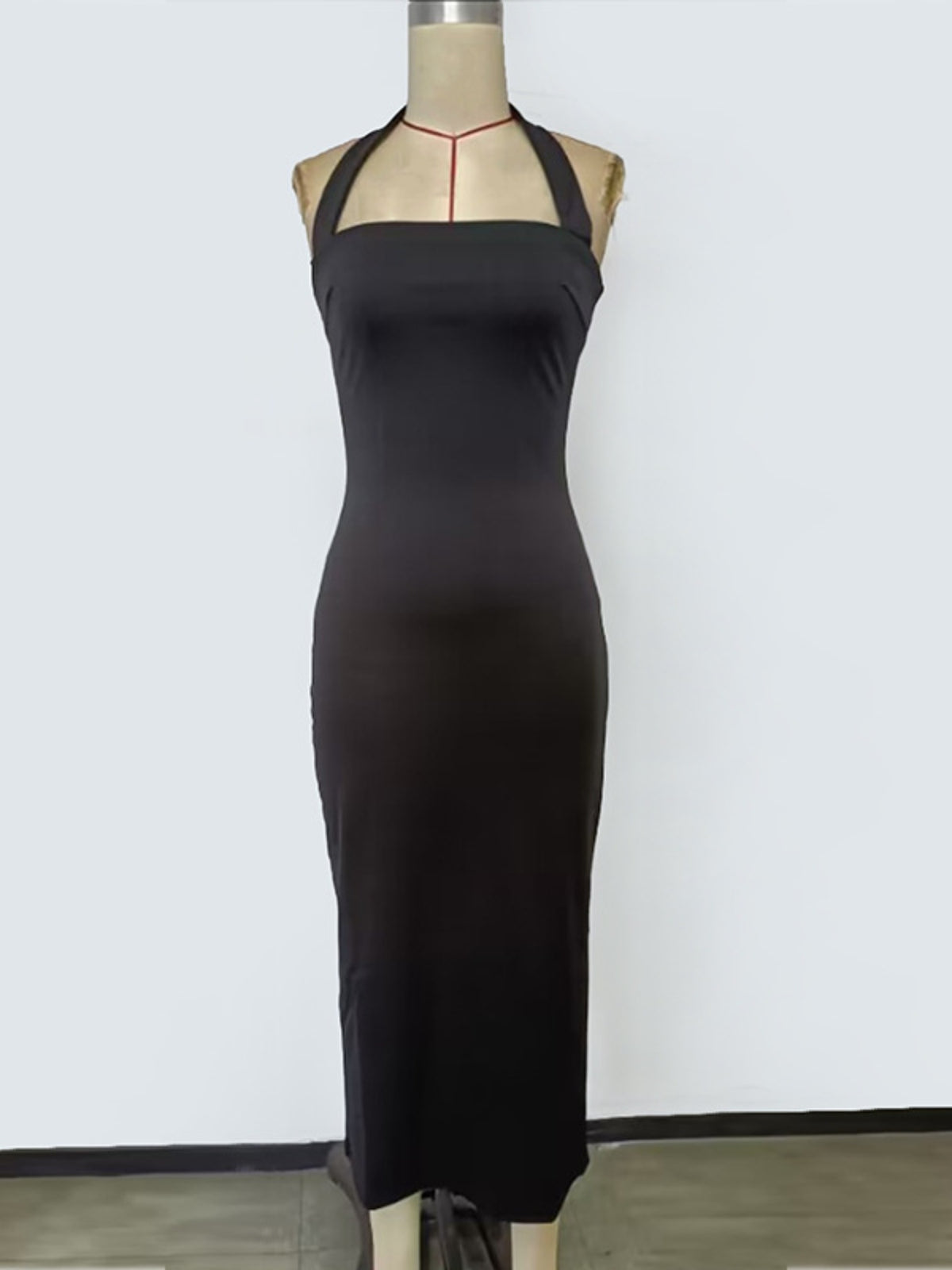 Three quarter view of the black halter dress