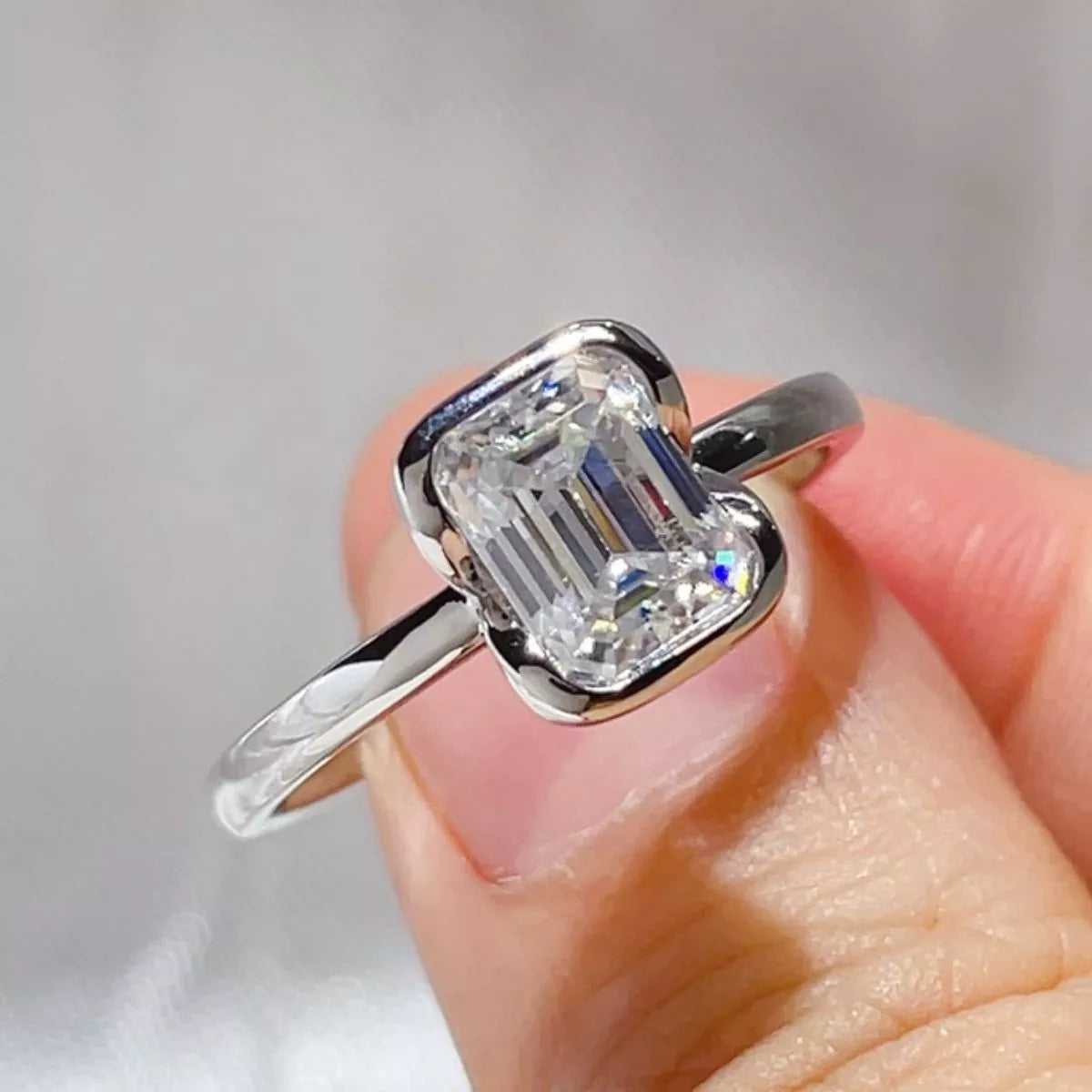 Close view of the step cut facets of the emerald cut moissanite stone