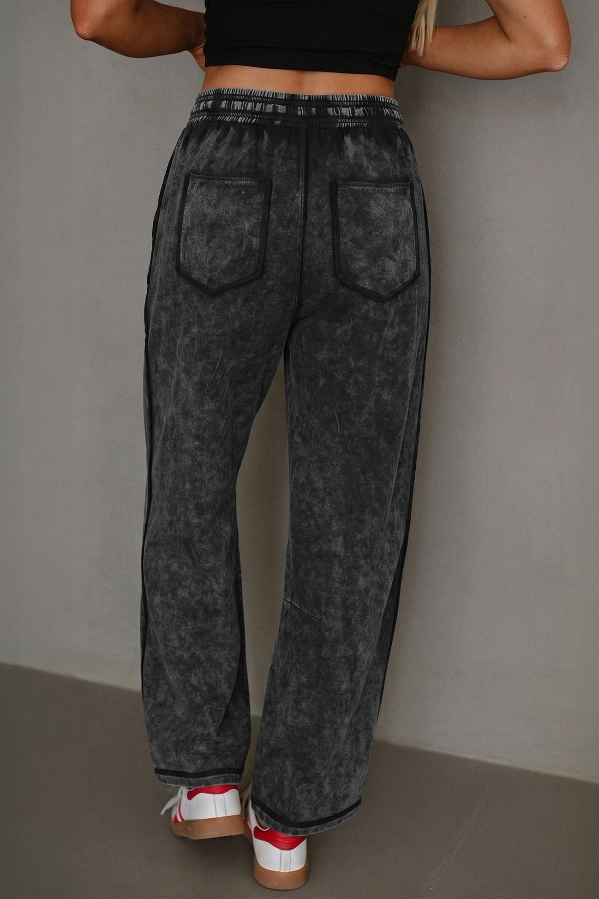 Black mineral wash barrel pants side view showing relaxed leg