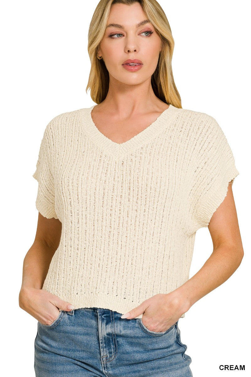Cream sweater vest V-neck detail