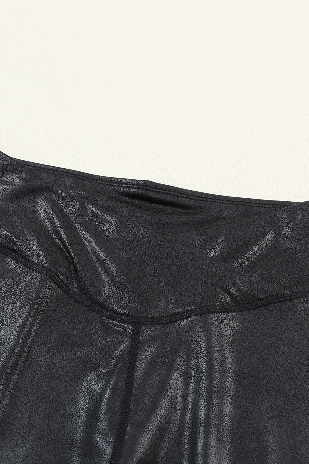 Woman wearing black high waist faux leather leggings