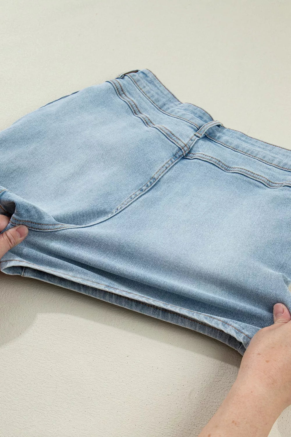 Light blue bow detail denim shorts back view