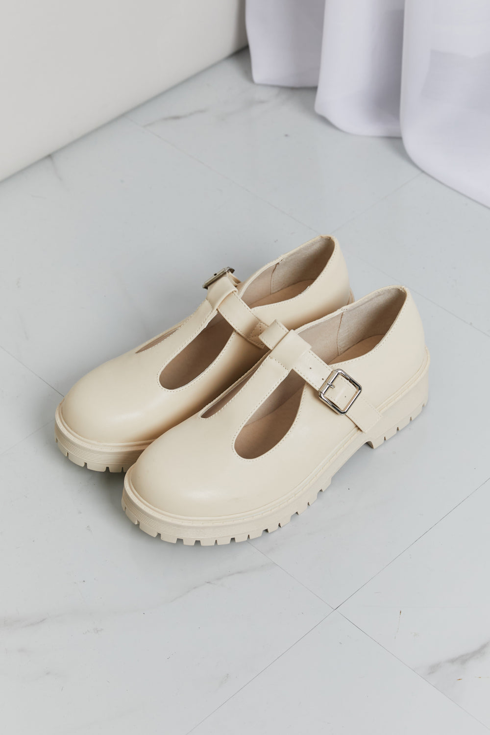Detail of the Mary Jane strap and faux leather upper