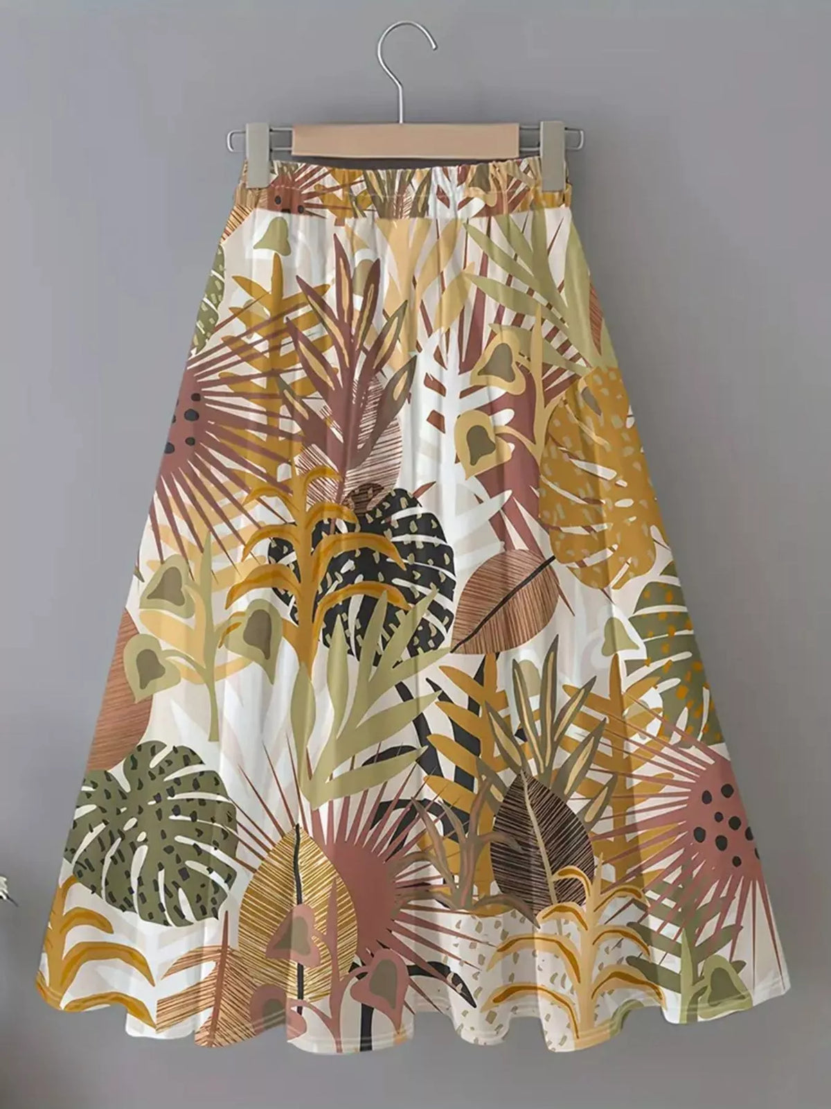 Dinosaur print midi skirt displayed against a soft background