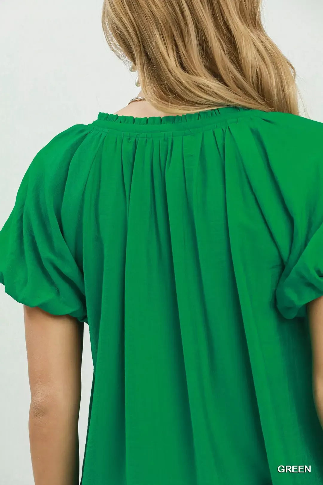 green gathered V neck top detail view