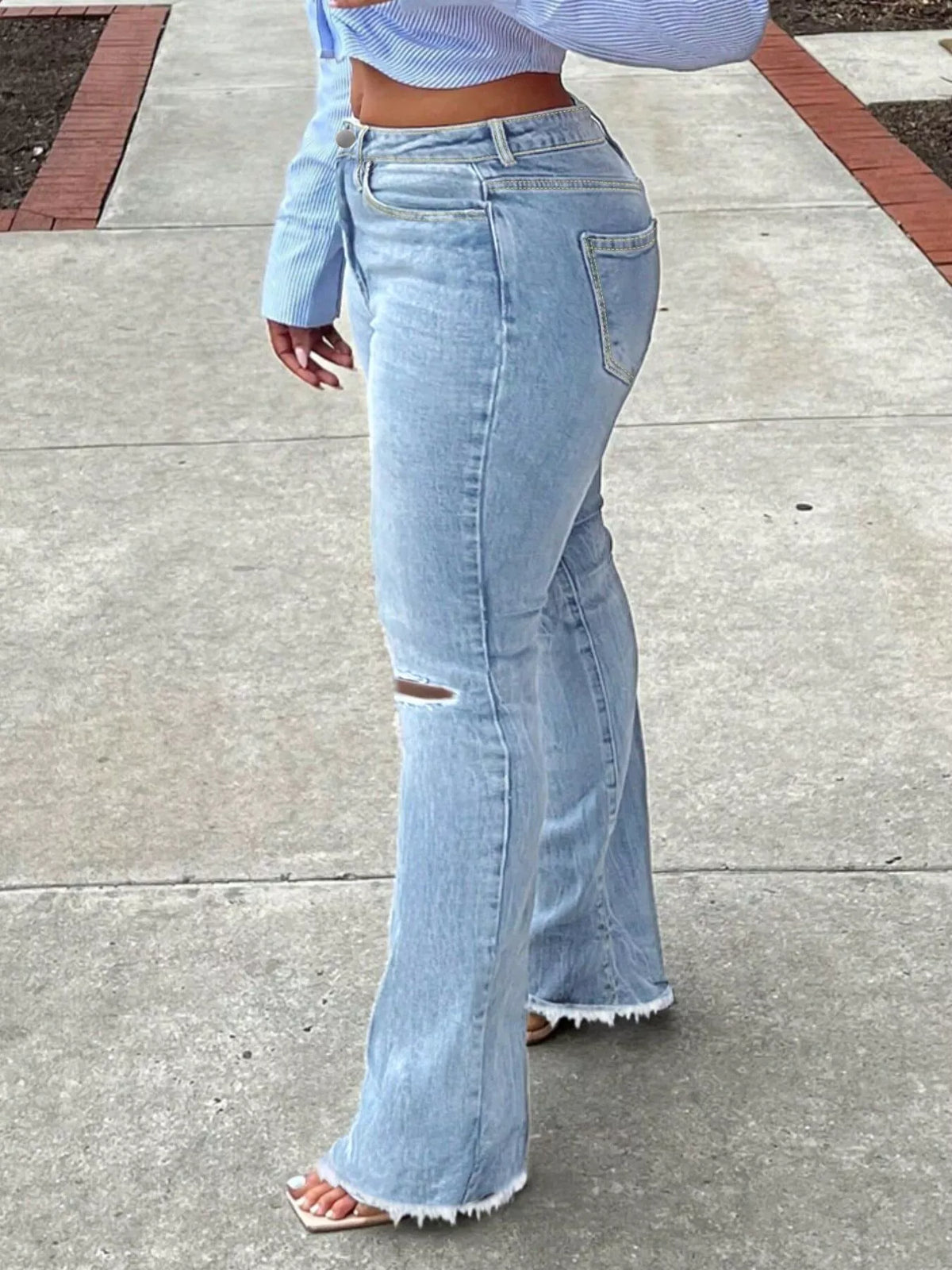 Ripped knee flare jeans side view