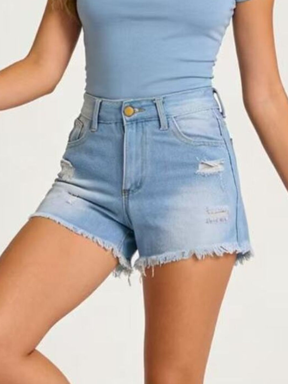 Seated view showing the fit of the denim shorts