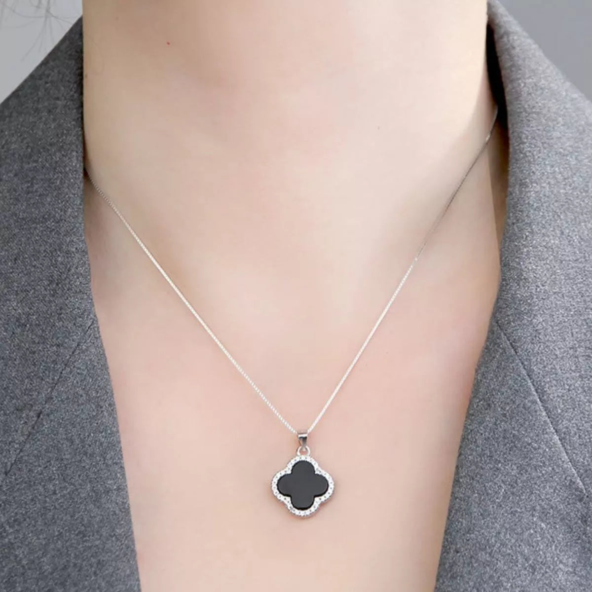 Extension chain detail on the silver clover necklace