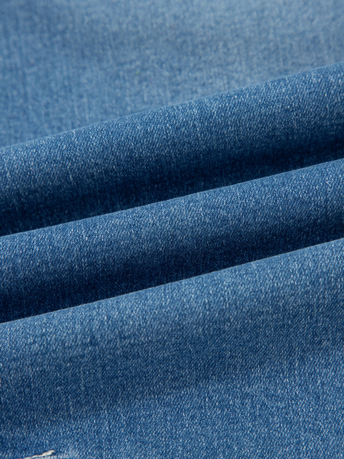 Washed barrel leg denim detail view