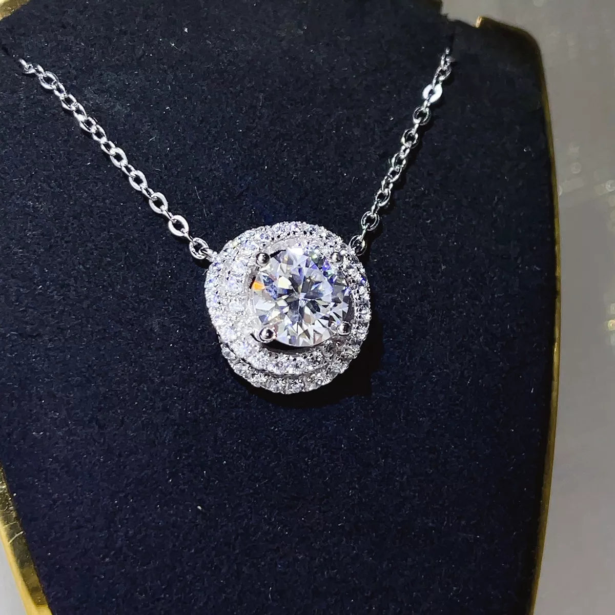 Moissanite pendant worn at the collarbone
