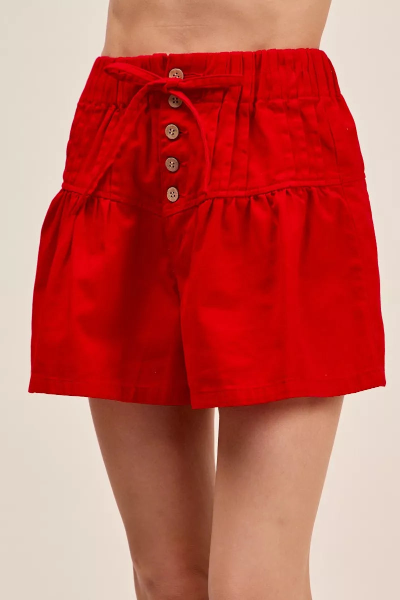 Red high waisted button front shorts with waist tie