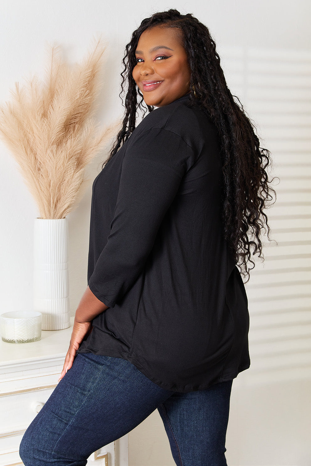Black draped open front cardigan styled on model