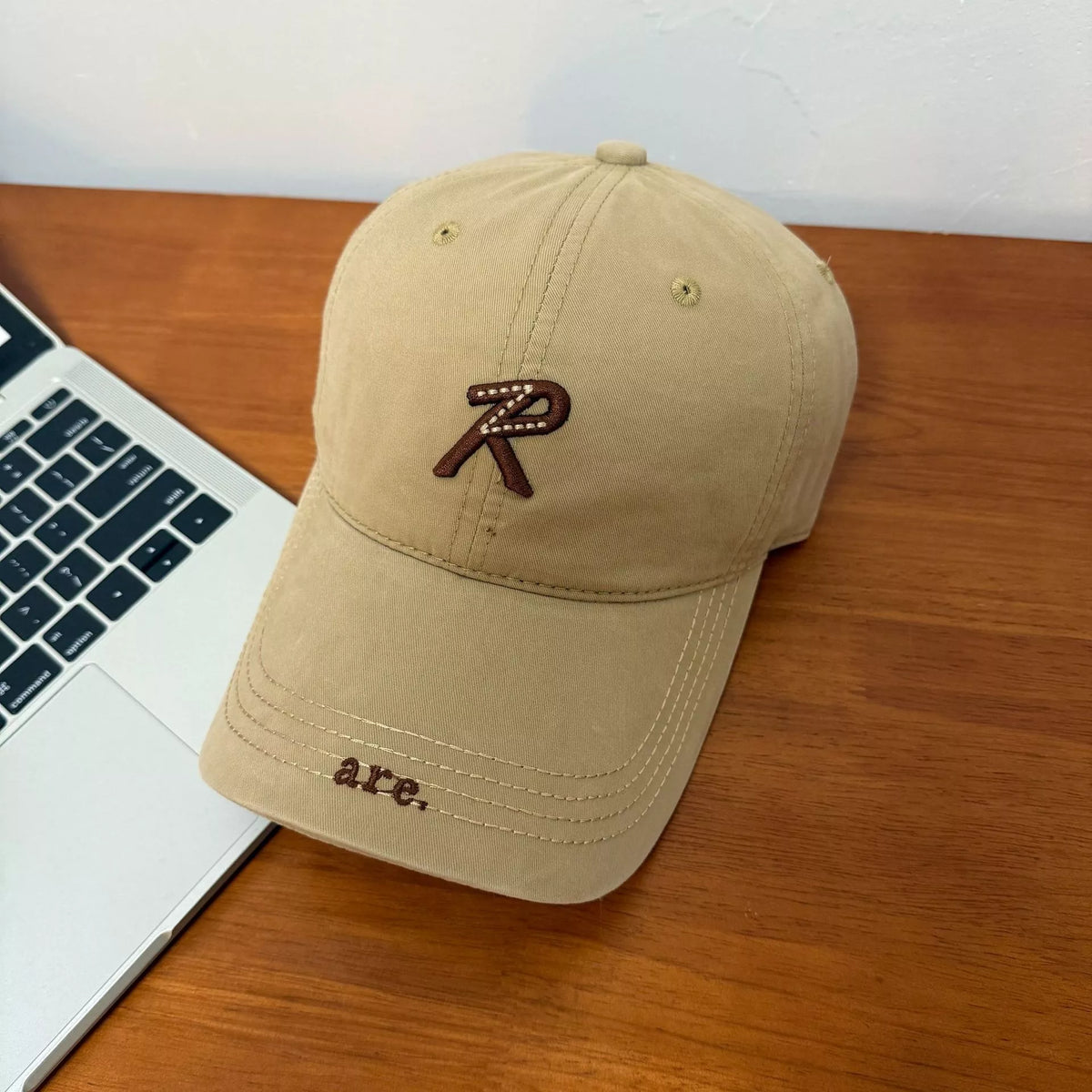 Letter embroidered baseball cap in khaki, front view