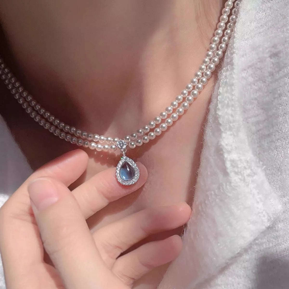 Double layered pearl teardrop pendant necklace side view