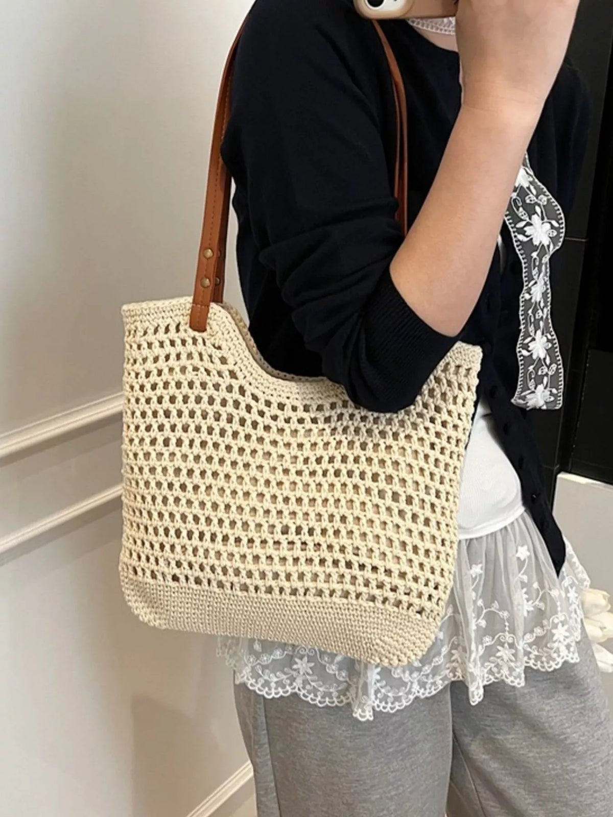 Woven straw bag carried on shoulder