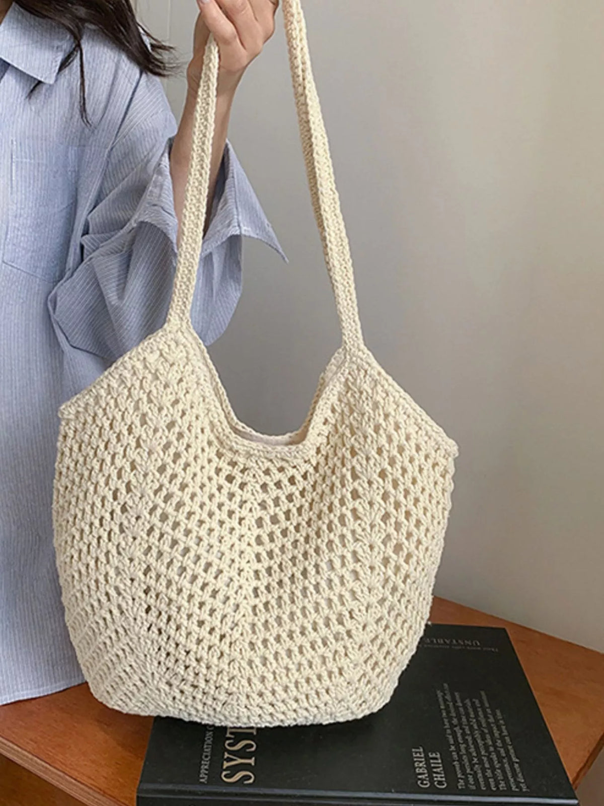 Straw shoulder bag styled for the beach