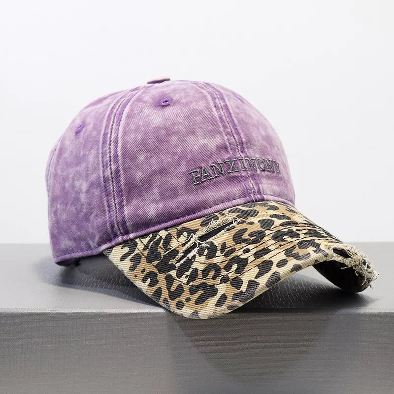 Distressed leopard print baseball cap with a washed purple crown