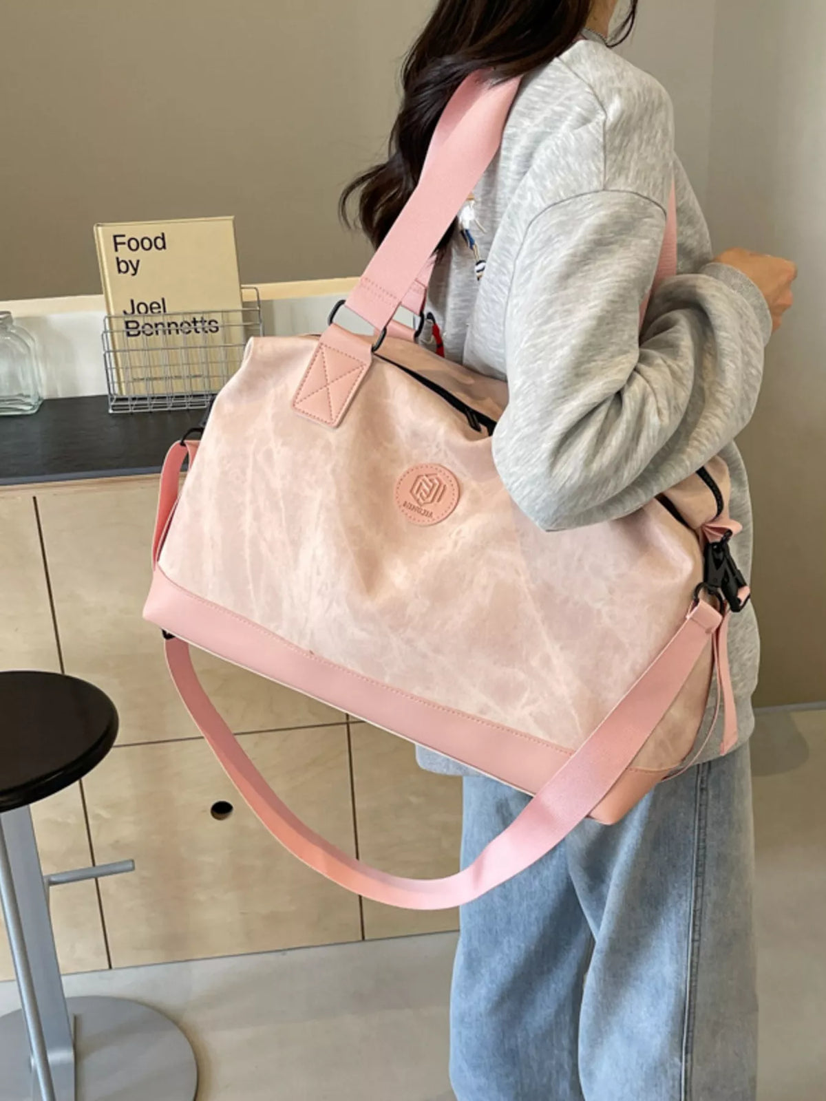 Pink leather duffel angled view