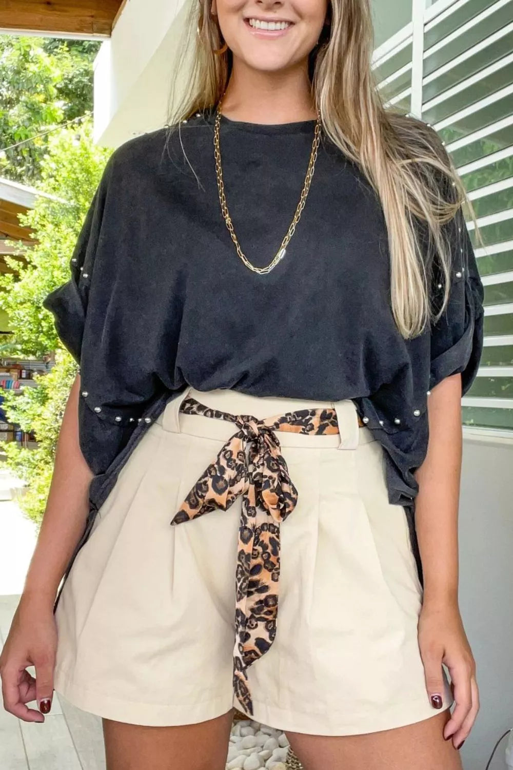 Beige high waisted pleated shorts detail view