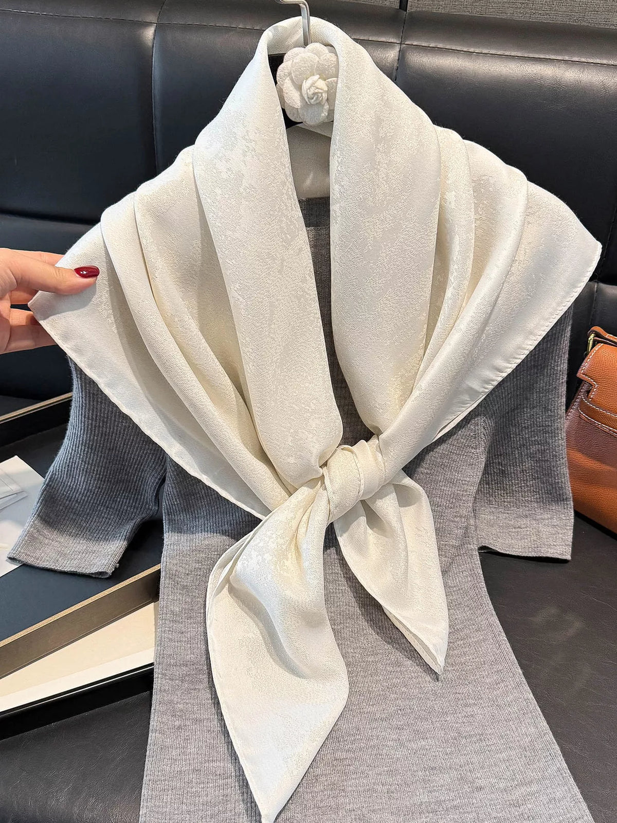 Bright silky scarf tied at the neck