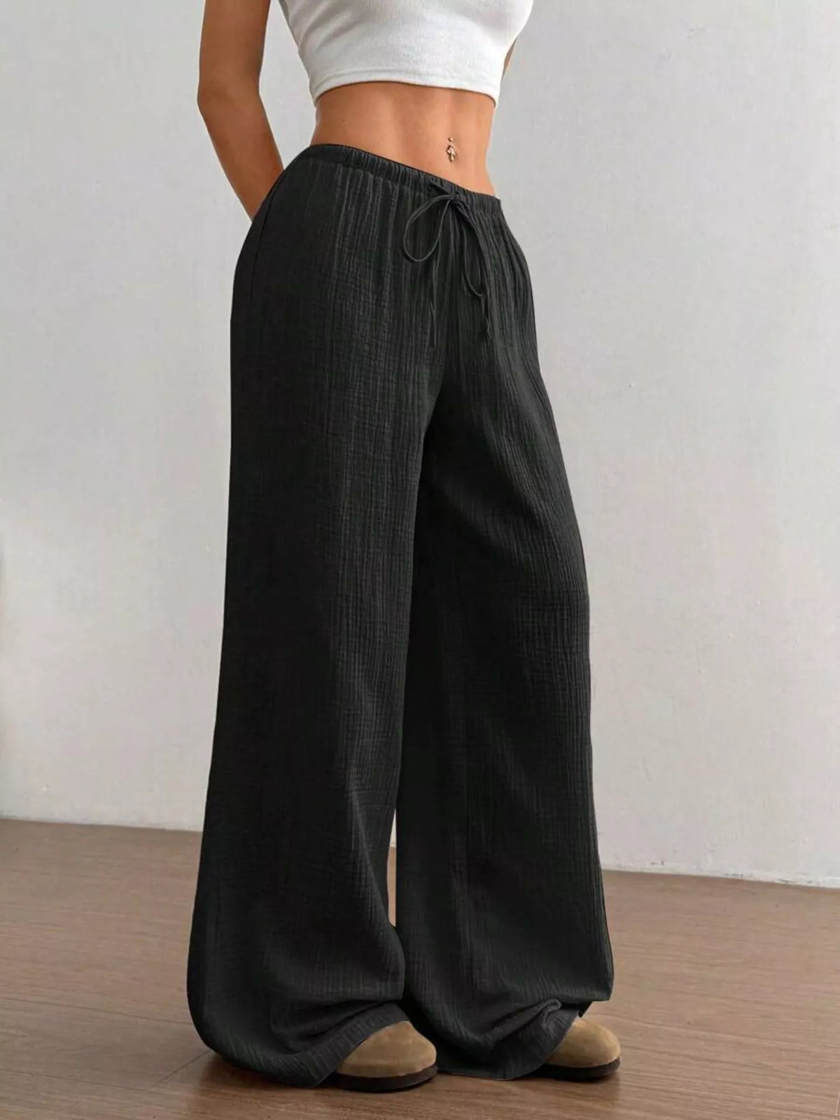 Wide leg pants shown with a cropped top