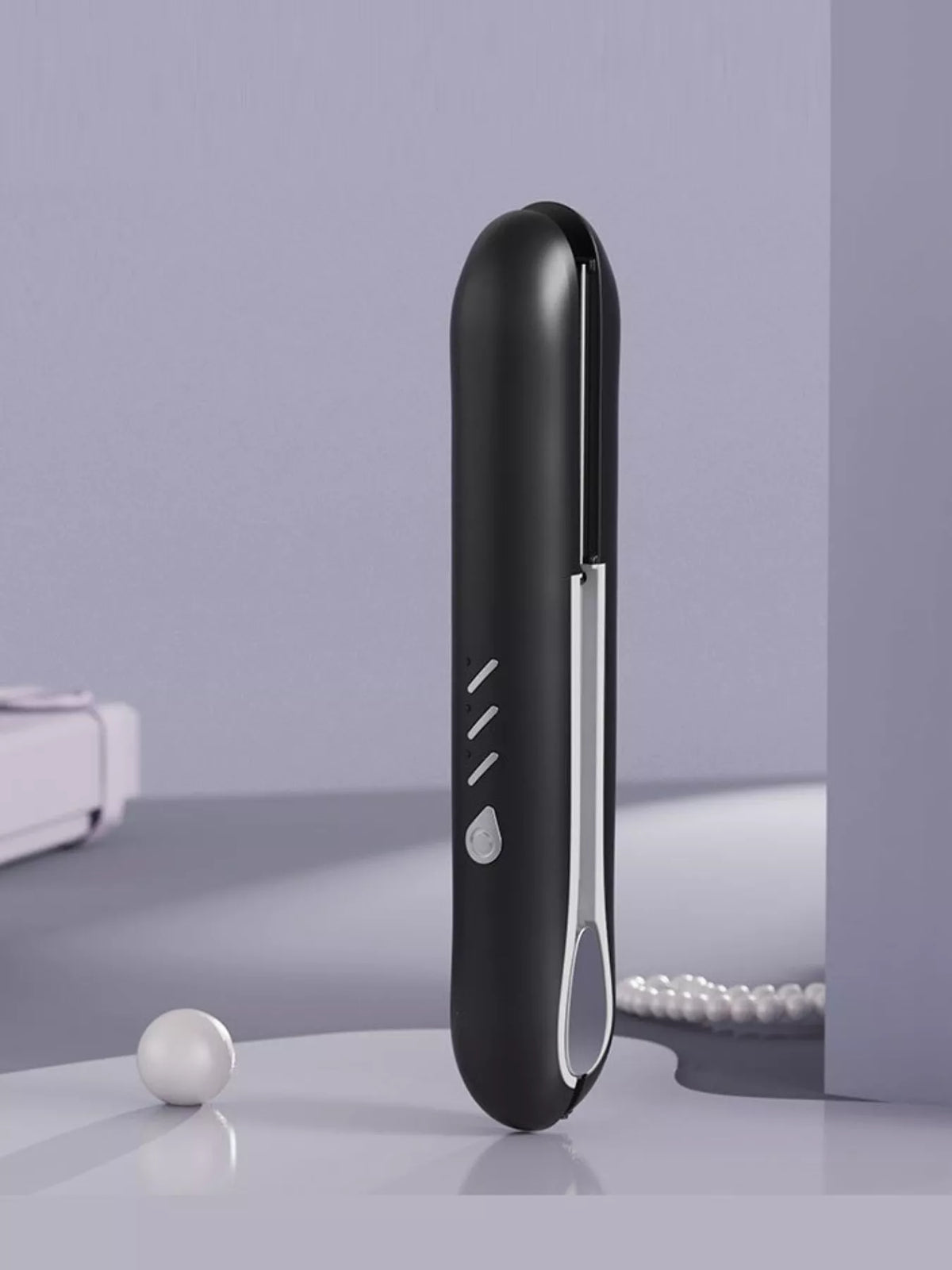 Hair straightener held in hand