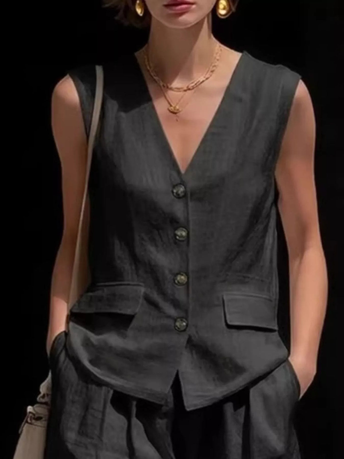 Close view of the buttoned front on the sleeveless vest