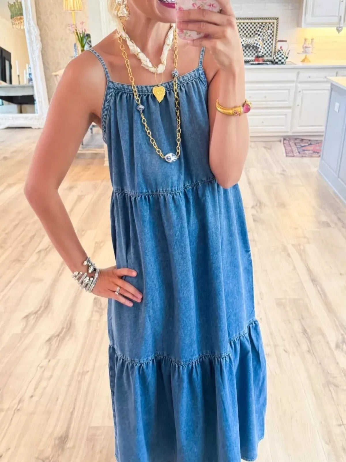Denim tiered dress side view showing ruffle hem