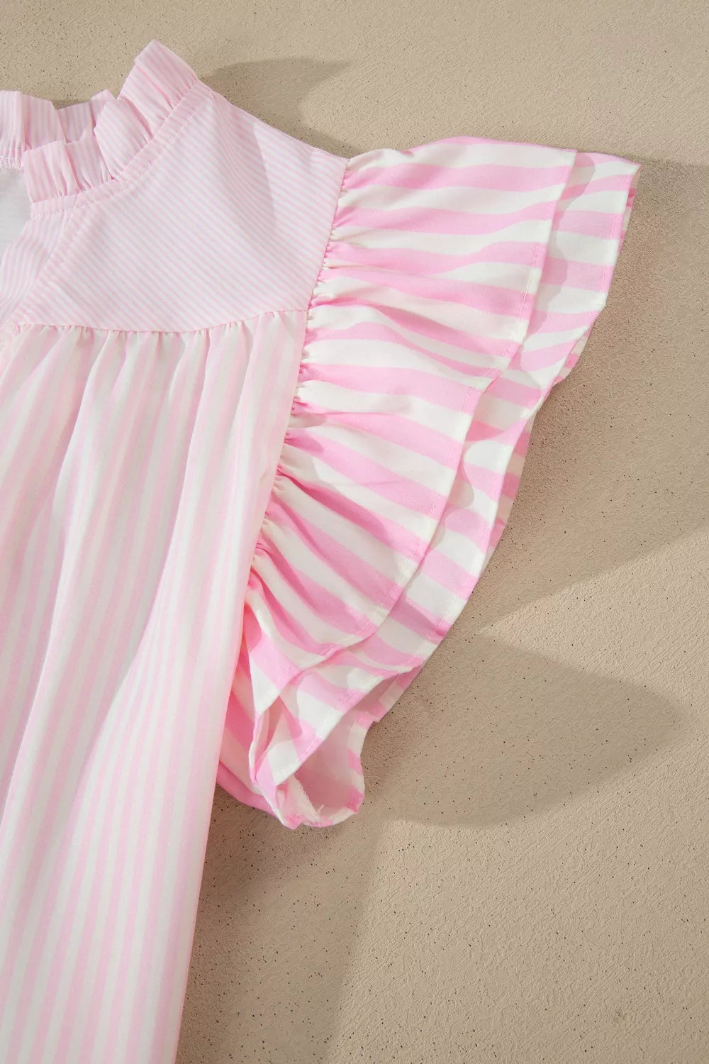 Blush pink striped contrast flutter sleeve blouse close up view